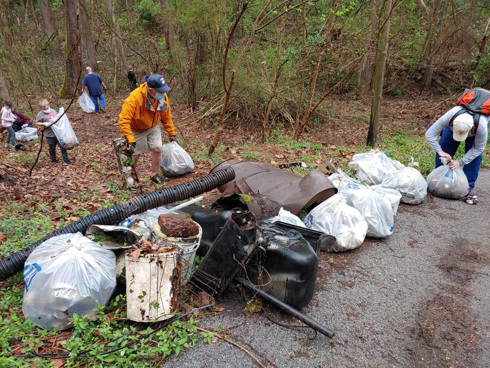 People collecting trash on hill IRR.jpg